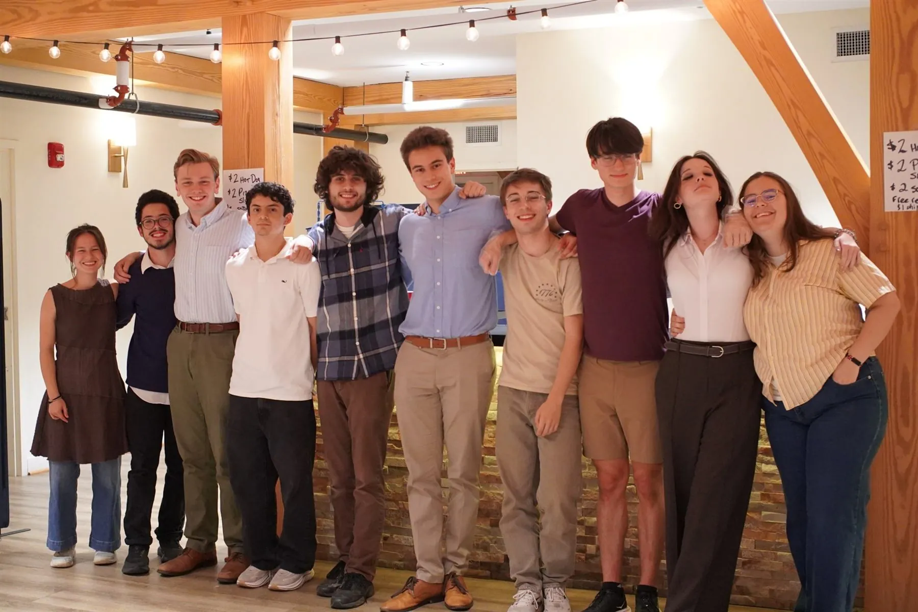 Students of Saint Augustine members standing arm in arm at a community gathering