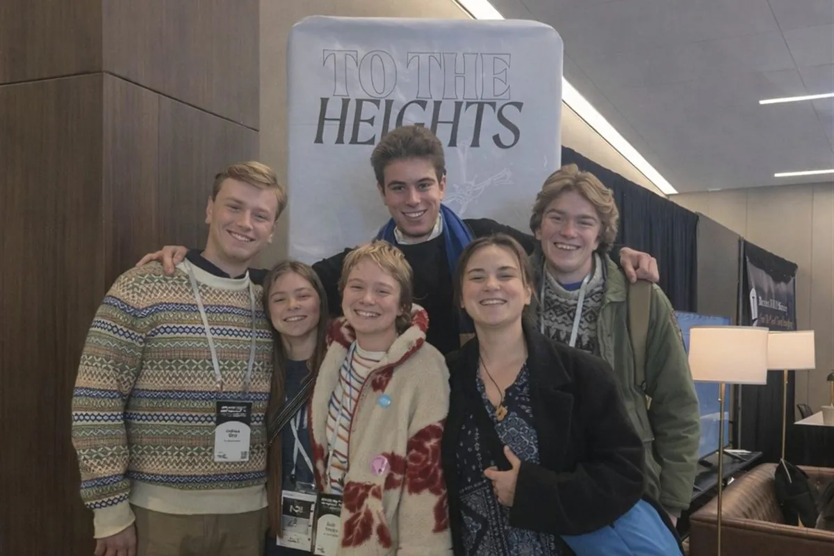Six students smiling in front of a To the Heights banner at SEEK 2026
